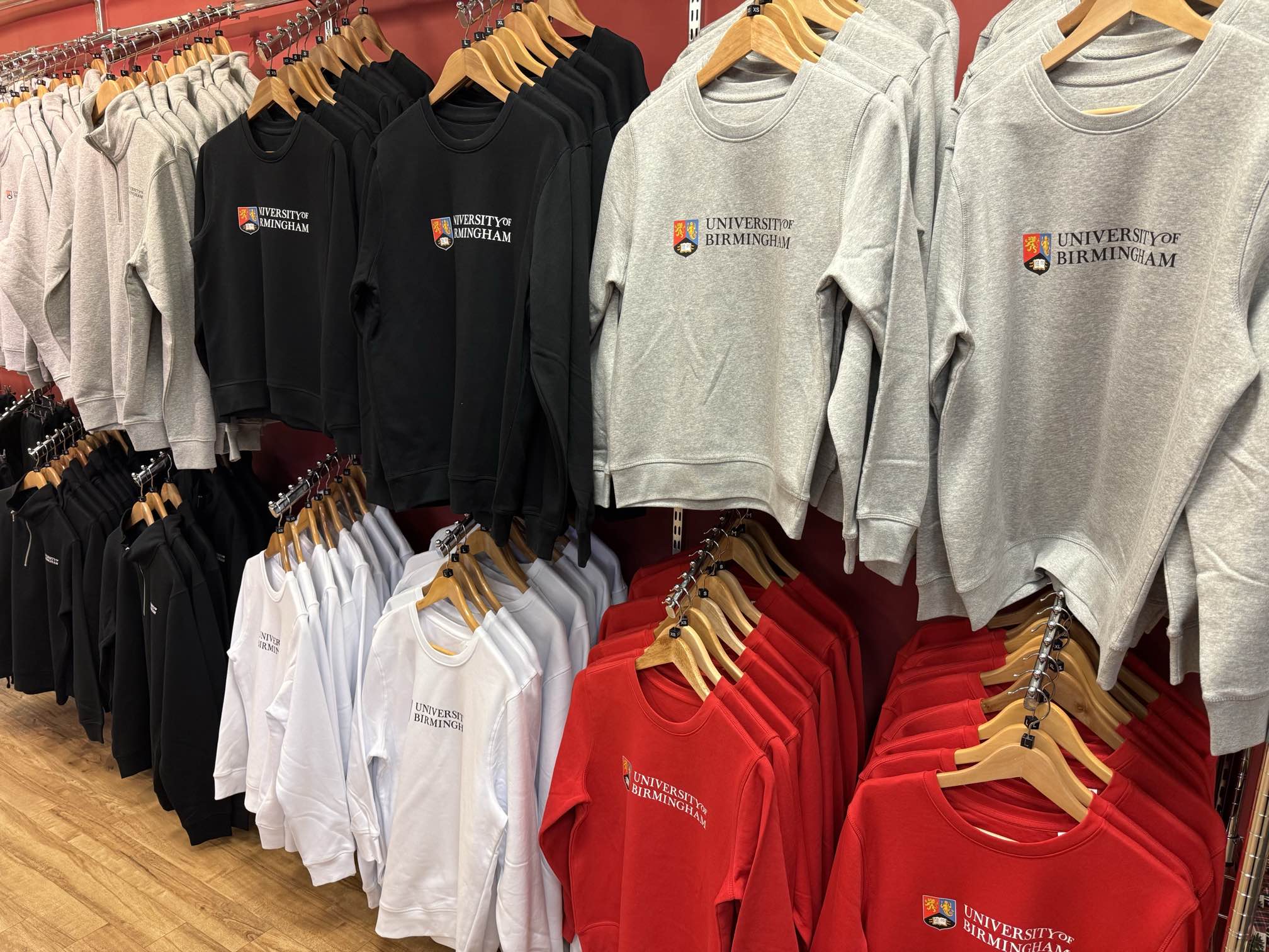 Display of University of Birmingham branded sweatshirts in the campus gift shop.